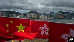 Chinese and Hong Kong flags are hung to celebrate the 25th anniversary of Hong Kong handover to China, in Hong Kong, June 17, 2022. Ahead of the anniversary, several democracies are urging Beijing to honor its commitments to ensure freedoms to the former British colony.
