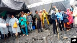 Hindu devotees are seen stranded after a cloudburst near the base camp of the holy cave shrine of Amarnath in south of Kashmir Himalayas, in India, July 8, 2022. 