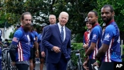 President Joe Biden talks to riders at the White House in Washington, June 23, 2022, during an event to welcome wounded warriors, their caregivers and families to the White House.
