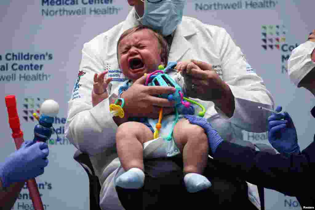 Oliver Harris, 9 months, cries after receiving a vaccine against the COVID-19 at Northwell Health's Cohen Children's Medical Center in New Hyde Park, New York, June 22, 2022.
