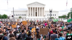 FILE - Demonstrators gather outside the Supreme Court in Washington, June 24, 2022. The Supreme Court has ended constitutional protections for abortion that had been in place nearly 50 years.
