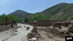 FILE - An Afghan man on a horse crosses a river in Sar-e Pol province, May 8, 2012. Taliban authorities are being accused of human rights abuses as they attempt to quell a rebellion in northern Sar-e Pol province in June 2022.