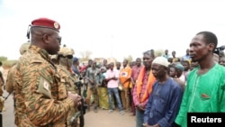 FILE - Burkina Faso President Lieutenant-Colonel Paul-Henri Damiba talks to local people in Seytenga, Burkina Faso, June 15, 2022, three days after armed men killed at least 79 people. (Burkina Faso's Presidential Press Service/Handout via Reuters)