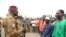 Burkina Faso President Lt. Colonel Paul-Henri Damiba talks to local people in Seytenga, Burkina Faso, June 15, 2022, three days after armed men killed at least 79 people. 