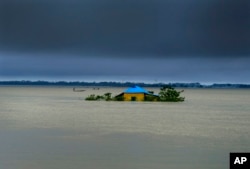 A house in marooned by flood waters in Sylhet, Bangladesh, June 20, 2022. Floods in Bangladesh continued to wreak havoc Monday with authorities struggling to ferry drinking water and dry food to flood shelters across the country's vast northern and northeastern regions.