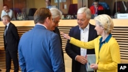 European Commission President Ursula von der Leyen, right, speaks with colleagues during a meeting of the College of Commissioners at EU headquarters in Brussels, June 17, 2022.