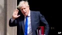 British Prime Minister Boris Johnson gestures as he leaves 10 Downing Street in London, on July 6, 2022.