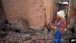 Hanna Sylivon, de 76 años, frente a su casa destruida por los ataques en Chernihiv, Ucrania, el domingo 19 de junio de 2022.