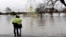 People look at a flooded park due to torrential rain in the Camden suburb of Sydney, Australia, July 3, 2022.