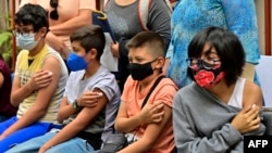 Children under the age of 11 wait after receiving a dose of the Pfizer-BioNTech vaccine against COVID-19, in Mexico City, on June 27, 2022.