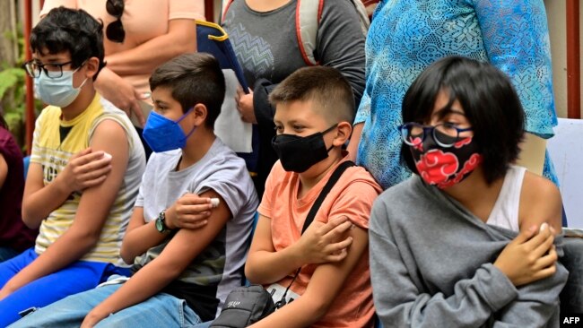 Children under the age of 11 wait after receiving a dose of the Pfizer-BioNTech vaccine against COVID-19, in Mexico City, on June 27, 2022.