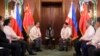 Philippine President Ferdinand Marcos Jr., center, talks with Chinese Foreign Minister Wang Yi during a courtesy call at the Malacanang Presidential Palace in Manila, Philippines on July 6, 2022. (Malacanang Presidential Photographers Division via AP)