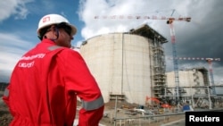 FILE - An employee of Sakhalin Energy stands at the Sakhalin-2 project's liquefaction gas plant in Prigorodnoye, about 70 km (44 miles) south of Yuzhno-Sakhalinsk, October 13, 2006. 