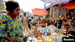 FILE - A woman shops at the Mvog Ada market in Yaounde, Cameroon, Jan. 29, 2022. 