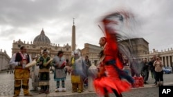 FILE - Assembly of First Nations members perform in St. Peter's Square at the Vatican on March 31, 2022. The Canadian government said Monday it had signed a $15.5 billion agreement to compensate First Nations children and families harmed by chronic underfunding of child welfare.