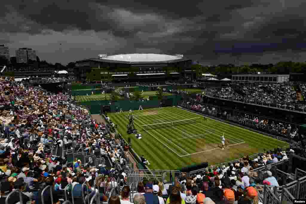 Netherlands' Tim van Rijthoven and Georgia's Nikoloz Basilashvili compete in a third round Wimbledon match at the All England Lawn Tennis and Croquet Club, London