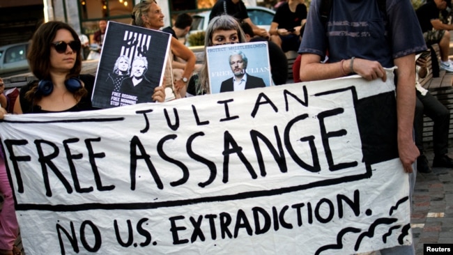 Supporters hold a banner during a protest against the extradition of WikiLeaks' founder Julian Assange from Britain to the U.S., in Athens, Greece, June 20, 2022.