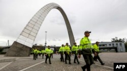 Police walk at a polling station in Bogota, on June 18, 2022, a day before the presidential runoff election.