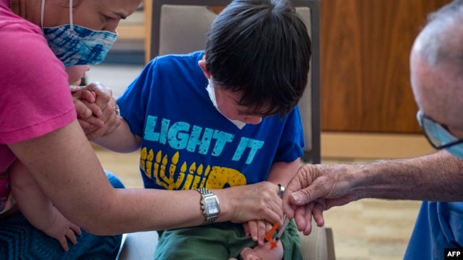 A 3-year-old receives his COVID-19 vaccination, with Moderna, at Temple Beth Shalom in Needham, Massachusetts on June 21, 2022.
