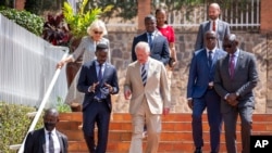 FILE: Britain's then-Prince Charles, center, and Camilla, then-Duchess of Cornwall, above-left, arrive at the Genocide Memorial in Kigali, Rwanda, June 22, 2022, ahead of a 54-nation Commonwealth summit.