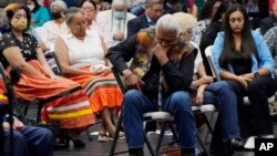 Ray Doyah, the first to speak on his experiences at an Indian boarding school, bows his head as he listens to others speak at a meeting to hear about the painful experiences of Native Americans who were sent to government-backed boarding schools designed 