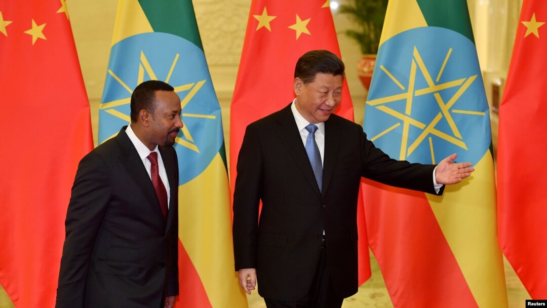 FILE - Ethiopia's Prime Minister Abiy Ahmed is shown the way by Chinese President Xi Jinping before their meeting at the Great Hall of the People in Beijing, Apr. 24, 2019. (Parker Song/Pool via Reuters) 