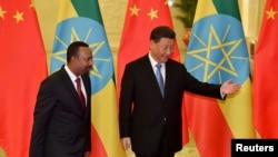 FILE - Ethiopia's Prime Minister Abiy Ahmed is shown the way by Chinese President Xi Jinping before their meeting at the Great Hall of the People in Beijing, Apr. 24, 2019. (Parker Song/Pool via Reuters) 