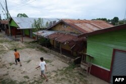 Children walk in Atalaia do Norte, state of Amazonas, Brazil, on June 22, 2022.