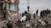 Rescuers extract a body from a residential building damaged by a Russian military strike in the town of Chasiv Yar, in Donetsk region, Ukraine, July 10, 2022. 