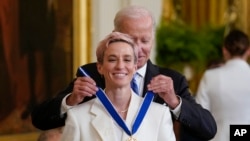 Presiden AS Joe Biden memberikan penghargaan Presidential Medal of Freedom kepada pesepak bola perempuan Megan Rapinoe di Gedung Putih, Washington, pada 7 Juli 2022. (Foto: AP/J. Scott Applewhite)