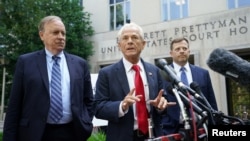 Peter Navarro, adviser to former U.S. President Donald Trump, flanked by lawyers John Rowley and John Irving, speaks after his arraignment on contempt of Congress charges, at U.S. District Court in Washington, June 17, 2022. 