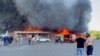 Smoke rises from a shopping mall hit by a Russian missile, in Kremenchuk, Ukraine, June 27, 2022. (Telegram/V_Zelenskiy_official/Handout via Reuters)