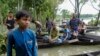 Flood affected people wait to receive relief material in Sylhet, Bangladesh, June 22, 2022.