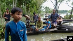 Flood affected people wait to receive relief material in Sylhet, Bangladesh, June 22, 2022.