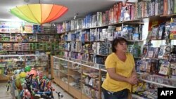 Viktoria Miroshnichenko answers AFP journalists' questions at her toy store in Kramatorsk, amid the Russian invasion of Ukraine, July 2, 2022. In the last few weeks, shops have slowly reopened in the eastern city, with many people returning to it, despite remaining dangers.