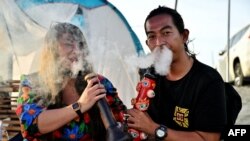 FILE - People smoke weed to celebrate the legalization of cannabis at the Thailand: 420 Legalaew! weekend festival hosted by Highland in Nakhon Pathom province on June 11, 2022.