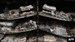 A photograph taken on June 28, 2022 shows charred goods in a grocery store of the destroyed Amstor mall in Kremenchuk, one day after it was hit by a Russian missile strike according to Ukrainian authorities.