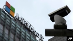 FILE - A security camera is seen near a Microsoft office building in Beijing, China, July 20, 2021. State-backed Russian hackers have engaged in “strategic espionage” against targets in 42 countries backing Ukraine, a new Microsoft report says.