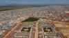 FILE - An aerial view shows a large refugee camp on the Syrian side of the border with Turkey, near Atma, in Idlib province, April 19, 2020. 