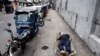 FILE PHOTO: A man sleeps on a folding bed on a pavement as he waits in queue to buy petrol due to fuel shortage, amid the country's economic crisis, in Colombo, Sri Lanka, June 17, 2022. 