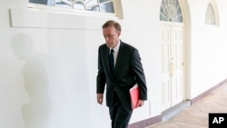 FILE - White House national security adviser Jake Sullivan walks along the Colonnade before a Rose Garden event at the White House, May 19, 2022. 