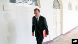 FILE - White House national security adviser Jake Sullivan walks along the Colonnade at the White House. 