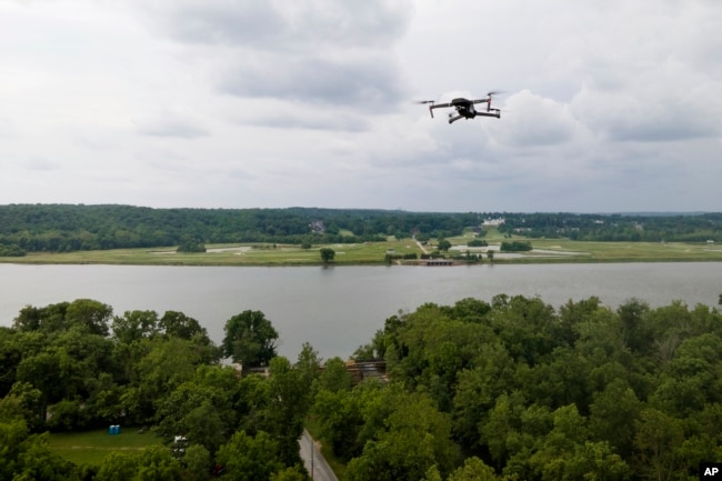 A drone operated by Martin Lively flies with the Potomac River at a distance during a training session in Poolesville, Md. (AP Photo/Julio Cortez)