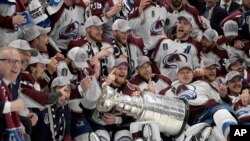 The Colorado Avalanche pose with the Stanley Cup after defeating the Tampa Bay Lightning 2-1 in Game 6 of the NHL hockey Stanley Cup Finals on June 26, 2022, in Tampa, Fla.