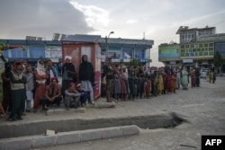 Afghan people queue up donate blood for the earthquake victims being treated at a hospital in the city of Sharan after an earthquake in Gayan district, Paktika province, June 22, 2022.