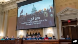 FILE - A video is displayed by the committee that claims to shows Proud Boys in front of the Capitol on Jan. 6, 2021, as the House select committee investigating the January 6 attack on the U.S. Capitol a hearing at the Capitol in Washington, June 9, 2022. 