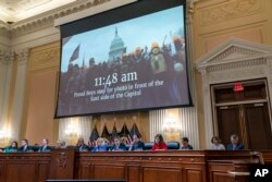 FILE - A video is displayed by the committee that claims to shows Proud Boys in front of the Capitol on Jan. 6, 2021, as the House select committee investigating the Jan. 6 attack on the U.S. Capitol a hearing at the Capitol in Washington, June 9, 2022.