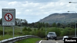 FILE - A car drives on the border between Northern Ireland and Ireland, in Carrickcarnan, Ireland, May 19, 2022. 