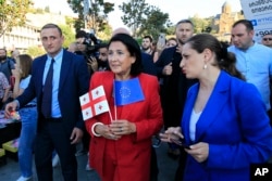 Georgian President Salome Zourabichvili, center, attends a public rally in support of Georgia's EU aspirations in Tbilisi, Georgia, June 16, 2022.