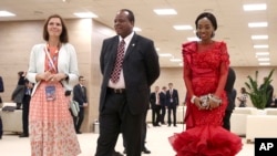 King Mswati III, of Swaziland and his wife, right, arrive to attend a welcome ceremony of the Russia-Africa summit in the Black Sea resort of Sochi, Russia, Oct. 23, 2019.